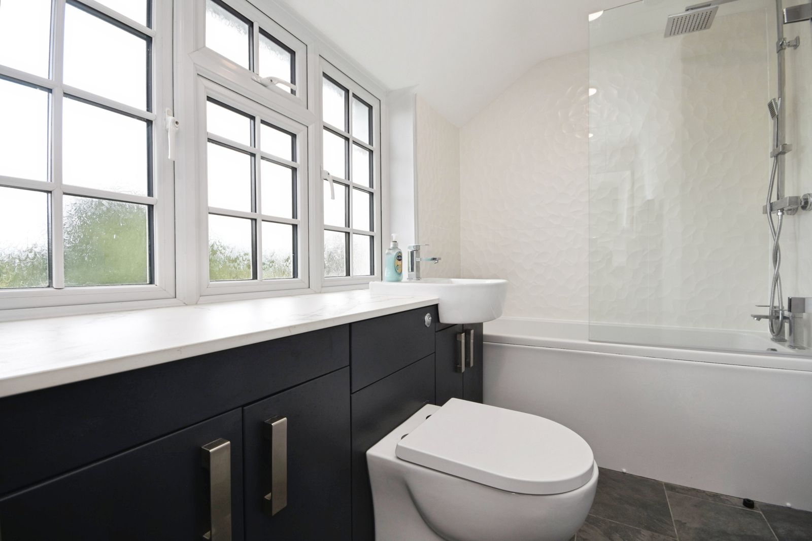 Family bathroom with tub and cottage windows