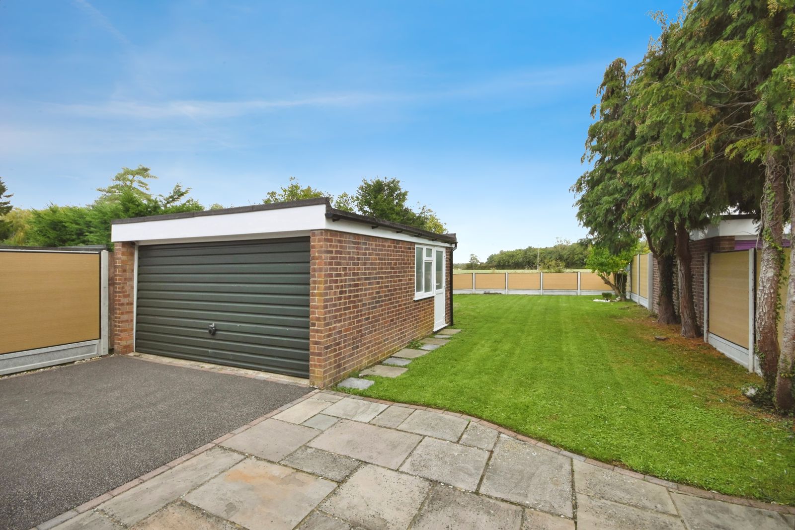 Detached garage beside the lawned garden