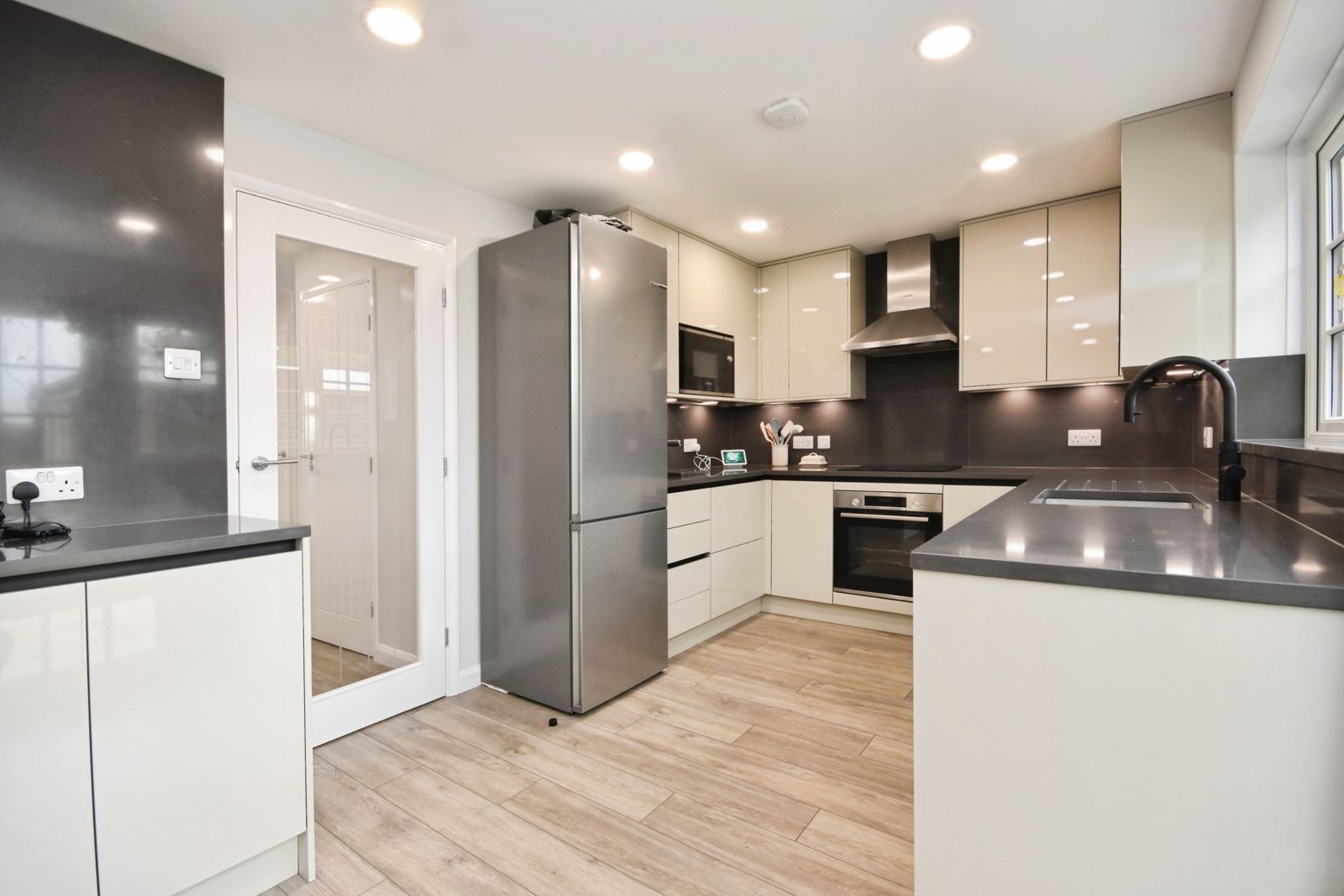 Kitchen with full-height fridge-freezer, oven and breakfast counter